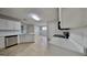 Bright kitchen featuring stainless steel appliances, white cabinetry, and tile flooring at 321 Shadowbrooke Dr, Loganville, GA 30052