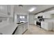 Modern kitchen with stainless steel appliances, quartz countertops, and tile floors at 321 Shadowbrooke Dr, Loganville, GA 30052