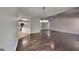 Open-concept living room showcasing hardwood floors, modern lighting, and a view into the kitchen at 321 Shadowbrooke Dr, Loganville, GA 30052
