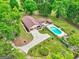 Stunning aerial view of a home featuring a pool, lush landscaping, and a long driveway at 171 Wynn Dr, Hampton, GA 30228