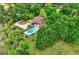 Aerial view of private estate with a pool, landscaping, and ample green space at 171 Wynn Dr, Hampton, GA 30228