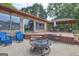 Large backyard with patio area, fire pit, grill, and gazebo at 171 Wynn Dr, Hampton, GA 30228