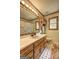 Bathroom featuring wood vanity with sink, medicine cabinet, and tile flooring, offering a functional and stylish space at 171 Wynn Dr, Hampton, GA 30228