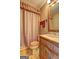 Cozy bathroom featuring decorative curtains, vanity with sink and towels at 171 Wynn Dr, Hampton, GA 30228