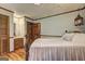 Traditional bedroom showing hardwood floors, and ensuite access at 171 Wynn Dr, Hampton, GA 30228