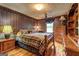 Cozy bedroom with hardwood floors, wood furnishings, ceiling fan, and warm lighting at 171 Wynn Dr, Hampton, GA 30228