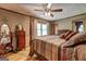 This primary bedroom suite has a four poster bed, natural light, and light wood floors at 171 Wynn Dr, Hampton, GA 30228
