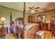 This primary bedroom features a four poster bed, matching furniture and lots of space at 171 Wynn Dr, Hampton, GA 30228