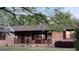 Charming brick home featuring a front porch with rocking chairs and a swing at 171 Wynn Dr, Hampton, GA 30228