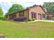 Charming brick home with well-maintained lawn and landscaping and a screened porch at 171 Wynn Dr, Hampton, GA 30228