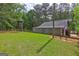 An exterior view featuring a block building, deer stand, and lush green surroundings at 171 Wynn Dr, Hampton, GA 30228