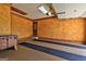 An empty garage featuring painted floors, paneled walls, and a side exterior door at 171 Wynn Dr, Hampton, GA 30228