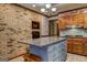 Kitchen with a brick wall, a granite island, and overhead lighting that creates a warm, inviting atmosphere at 171 Wynn Dr, Hampton, GA 30228