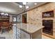 Spacious kitchen with island, brick accent wall, and built-in microwave and oven; perfect for cooking and entertaining at 171 Wynn Dr, Hampton, GA 30228