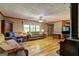 Cozy living room with hardwood floors, wood-burning stove, and large windows at 171 Wynn Dr, Hampton, GA 30228