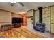 Living room showcasing a brick fireplace, wood floors and built-in shelving at 171 Wynn Dr, Hampton, GA 30228