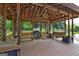 Covered outdoor kitchen featuring lots of bench seating, a grill, and a ceiling fan at 171 Wynn Dr, Hampton, GA 30228