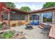 Outdoor patio with fire pit and seating area next to brick home at 171 Wynn Dr, Hampton, GA 30228