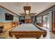 Large game room with pool table, fireplace, wainscoting, and ample natural light at 171 Wynn Dr, Hampton, GA 30228
