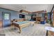 Large game room featuring a pool table, a fireplace, and wainscoting at 171 Wynn Dr, Hampton, GA 30228