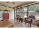 Cozy sunroom with tile flooring and windows overlooking the backyard, creating a peaceful indoor-outdoor living space at 171 Wynn Dr, Hampton, GA 30228
