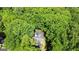 Aerial view showcasing a home with a pool and deck nestled among lush green trees at 139 Crown Forest Dr, Mcdonough, GA 30252