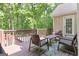 Inviting back deck featuring wicker seating and table perfect for outdoor relaxation surrounded by lush greenery at 139 Crown Forest Dr, Mcdonough, GA 30252