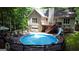 The above-ground pool features a slide and is set amid wooded backyard views, perfect for recreation at 139 Crown Forest Dr, Mcdonough, GA 30252