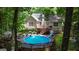 This outdoor space features an above-ground pool with a slide, perfect for recreation and relaxation at 139 Crown Forest Dr, Mcdonough, GA 30252