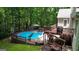 The backyard of this home features an above-ground pool, slide, outdoor dining and swing set, perfect for entertainment at 139 Crown Forest Dr, Mcdonough, GA 30252