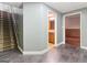 Finished basement hallway featuring tile floors, a staircase, and doorways to a bathroom and bedroom at 139 Crown Forest Dr, Mcdonough, GA 30252