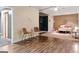 Finished basement area showcasing hardwood floors, two chairs, and a bedroom in the background at 139 Crown Forest Dr, Mcdonough, GA 30252