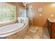 Elegant bathroom with a soaking tub and a glass-enclosed shower at 139 Crown Forest Dr, Mcdonough, GA 30252