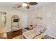 Charming bedroom with hardwood floors, ceiling fan, and a delightful wall decor at 139 Crown Forest Dr, Mcdonough, GA 30252