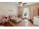 bedroom with wood floors, ceiling fan, and decorated wall with daisy accents at 139 Crown Forest Dr, Mcdonough, GA 30252
