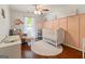 Bedroom featuring wood floors, a white crib, and comfortable chair with ottoman at 139 Crown Forest Dr, Mcdonough, GA 30252