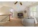 Bright bonus room featuring a window, ceiling fan, TV, and an adjacent doorway at 139 Crown Forest Dr, Mcdonough, GA 30252