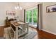 Bright dining room with large windows and a rustic farmhouse table at 139 Crown Forest Dr, Mcdonough, GA 30252