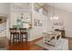 Open dining area with rustic table and chair set and modern chandelier at 139 Crown Forest Dr, Mcdonough, GA 30252