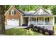 Lovely exterior view with brick, manicured landscaping, and a two-car garage at 139 Crown Forest Dr, Mcdonough, GA 30252