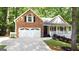 Two-story home boasting a manicured lawn, inviting porch, and convenient attached two-car garage at 139 Crown Forest Dr, Mcdonough, GA 30252