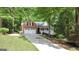 Inviting home with brick facade, front porch and two-car garage nestled amongst mature trees at 139 Crown Forest Dr, Mcdonough, GA 30252