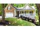 Charming home featuring a welcoming front porch, brick accents, and a well-manicured lawn at 139 Crown Forest Dr, Mcdonough, GA 30252
