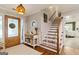 Welcoming foyer featuring hardwood floors, open staircase, and decorative furnishings at 139 Crown Forest Dr, Mcdonough, GA 30252