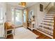 Inviting foyer featuring hardwood floors, a decorative rug, and a staircase to the upper level at 139 Crown Forest Dr, Mcdonough, GA 30252