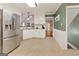 Bright kitchen featuring stainless steel appliances, white cabinetry and tile floors at 139 Crown Forest Dr, Mcdonough, GA 30252