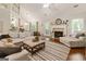 Bright living room with fireplace, neutral decor, and large windows at 139 Crown Forest Dr, Mcdonough, GA 30252
