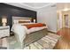 Spacious main bedroom features a dark accent wall and hardwood floors at 139 Crown Forest Dr, Mcdonough, GA 30252