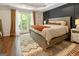 Charming main bedroom with hardwood floors, tray ceiling, and a large window at 139 Crown Forest Dr, Mcdonough, GA 30252