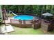 The above-ground pool features a slide and is set amid a wooded backyard, perfect for cooling off on warm summer days at 139 Crown Forest Dr, Mcdonough, GA 30252